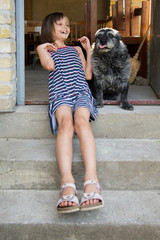 the girl is playing with a dog