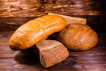 Different loafs of bread on wooden table