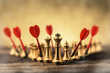 business strategy ideas concept with golden chess with red dart arrow