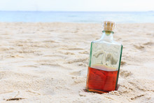 Beverrage Alcohol Is Brandy Bottle On Sand Beach.