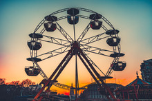 Ferris Wheel Silhouette At Sunset Against The Colorful Evening Skyline At Dusk - Popular Children Attraction In Park. Vintage Retro Toning Filter