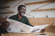 © LIGHTFIELD STUDIOS - businessman with newspaper in cafe