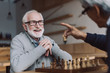 © LIGHTFIELD STUDIOS - senior men playing chess