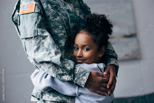 daughter hugging soldier