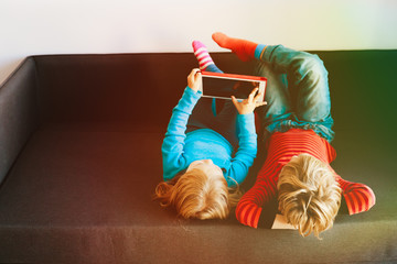 Wall Mural - little boy and girl looking at touch pad at home