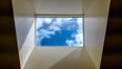 Modern interior skylight showing grey sky and misty clouds. Black and white skylight in modern office building. Abstract, artistic image of sky and clouds