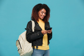 Wall Mural - Pleased african woman in leather jacket with backpack