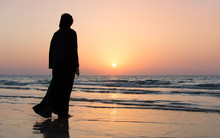 Woman In Hijab Standing On The Beach