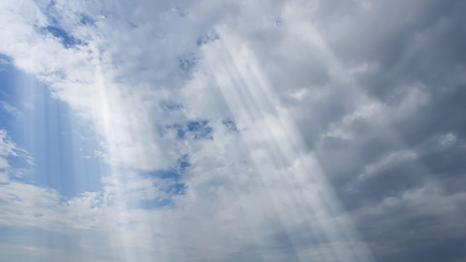 Poster - dramatic sun rays and clouds as background