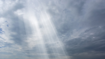 Poster - dramatic sun rays and clouds as background