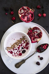 Wall Mural - Yoghurt with cereals and fresh forest fruits and sliced pomegranate. Health care concept.