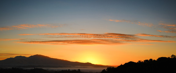 Mount Diablo sunrise panorama over Contra Costa County California showing high clouds and orange sky