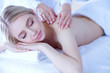 © lenets_tan - Young woman lying on a massage table,relaxing with eyes closed. Woman. Spa salon