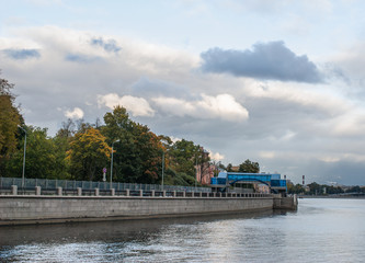 City landscape. The autumn embankment. View from the water