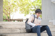 © zephyr_p - Young Asian man sitting on stair and working with laptop in college building, university student or high school lifestyle. education concept