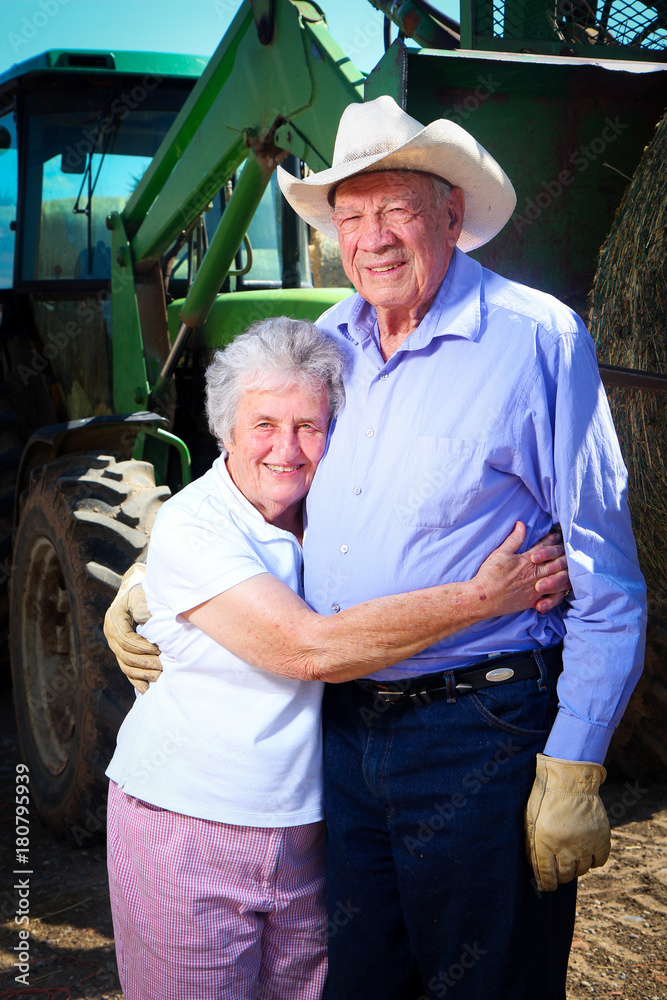Elderly Farmer with his Wife in front of tractor Stock Photo | Adobe Stock