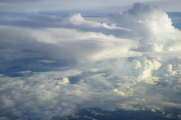 Wall Mural - view of abstract soft free form wind blow white cloud with shades of blue sky background from above 