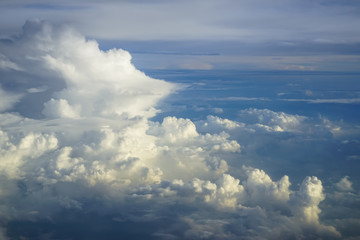 Wall Mural - view of abstract dense soft fluffy white cloud copyspace with shades of blue sky and earth backgroun
