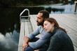 © ChadBridwell - Black and white couple cuddling at the lake