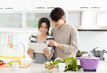 young asian couple cooking in kitchen