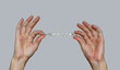 Man two hands holding a mercury thermometer and shows thumb up