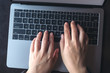 © Farknot Architect - Top view image of business woman's hands typing on laptop on vintage wooden table