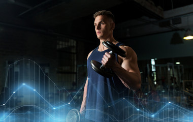 Wall Mural - young man with dumbbells exercising in gym