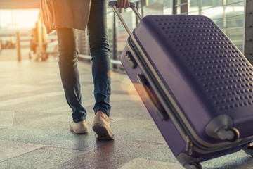 traveler with suitcase in airport concept.young girl walking with carrying luggage and passenger for