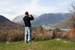 A boy photographing the landscape where the Sangro river gives rise to the lake Barrea.