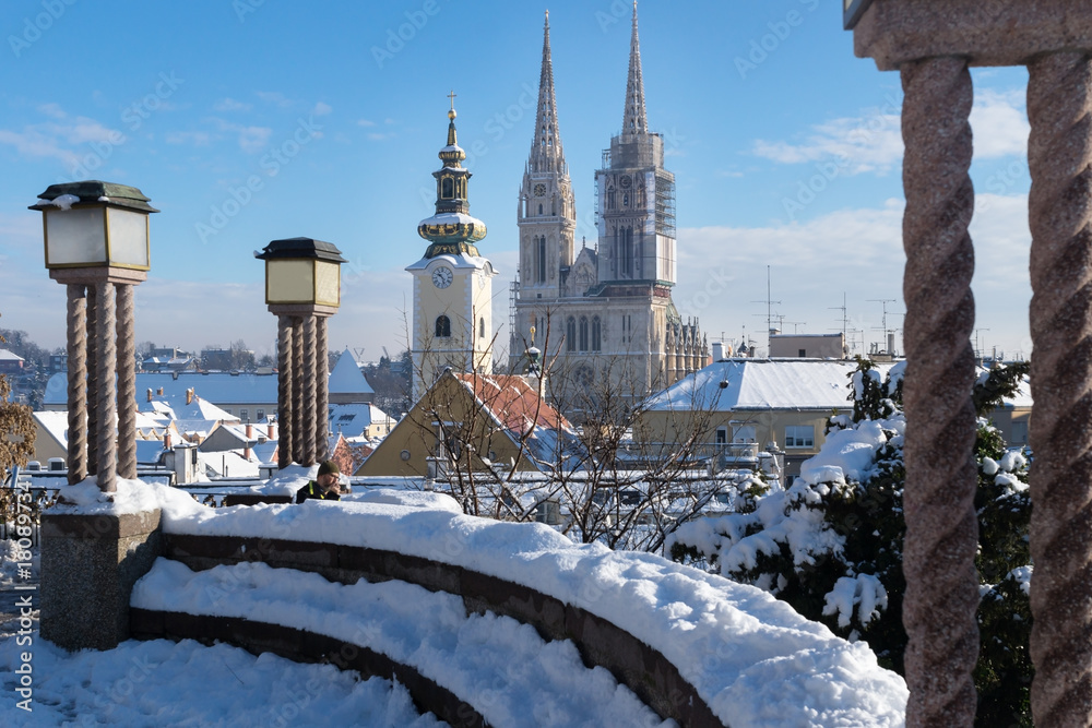 Obraz na płótnie View over Zagreb during winter with snow with view to towers of church and cathedral and seating area with laternsat a sunny day, Zagreb, Croatia, Europe w salonie