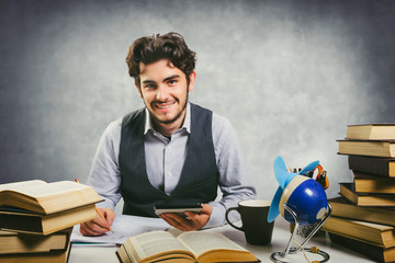 Wall Mural - smiling young student sitting at desk