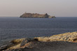 Corsica, 29/08/2017: tramonto sull'isola di Giraglia all'estremità settentrionale del Capo Corso nel Mar Mediterraneo, con vista del faro della Torre genovese