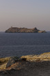 Corsica, 29/08/2017: tramonto sull'isola di Giraglia all'estremità settentrionale del Capo Corso nel Mar Mediterraneo, con vista del faro della Torre genovese