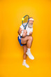 © deagreez - Body care, hobby, weight loss, game process. Competetive emotional cool grandpa with humor grimace exercising holding equipment, swatting ball with strength and power scared