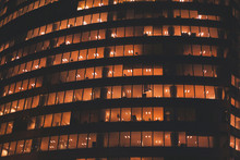 Yellow Light In Windows Of Office Building By Night, Business Tower Exterior