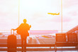 © Song_about_summer - people in airport waiting for departure, silhouette of woman passenger traveling with luggage