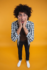 Wall Mural - Full lemgth portrait of a shocked astonished african man