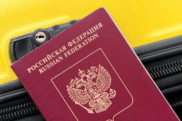 Wall Mural - Russian passport on a yellow suitcase