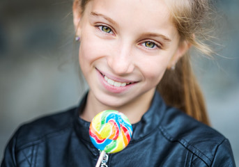 Wall Mural - Beautiful little girl with candy, outdoor