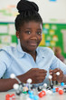 © highwaystarz - Female Pupil Using Molecular Model Kit In Science Lesson