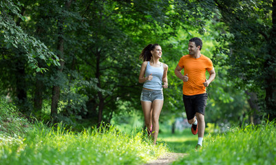 Wall Mural - Happy couple running and jogging together