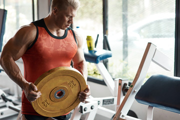 Professional strong man holding barbell plate