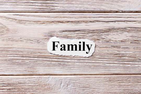 Family of the word on paper. concept. Words of Family on a wooden background