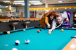 © NDABCREATIVITY - Couple playing billiards