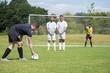 Soccer player is ready to kick ball from penalty spot