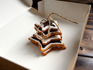 The recipe for making ginger biscuits. Ginger cookies in the form of a star tied up by a cord in a box.