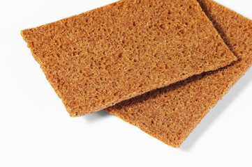 Two pieces of rye bread on white background