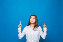Smiling Young Woman Pointing Finger Up Over Blue Background