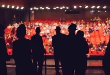 Actors performers on stage and audience waiting for show to start,blurry image