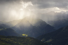 Light Rays Filter Through A Cloud In A Thunderstorm Illuminating The Valley In Front Of The Nuvolau Refuge, Dolomites, Cortina D'Ampezzo, Italy